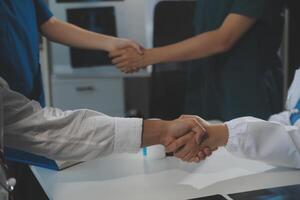 Doctor handshake and partnership in healthcare, medicine or trust for collaboration, unity or support.Team of medical experts shaking hands in teamwork for or success in hospital photo