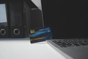 Calculator on a dark background, plastic cards and banknotes photo