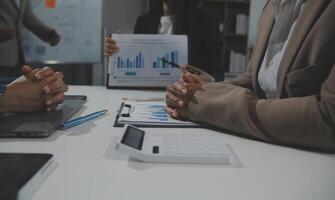 Business team collaboration discussing working analyzing with financial data and marketing growth report graph in team, presentation and brainstorming to strategy planning making profit of company. photo