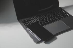 Laptop with tablet and smartphone on white background photo