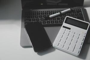 Office leather desk table with calculator and pen. Top view with copy space photo