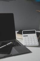 Flat lay, top view office table desk. Workspace with calculator,pen,laptop on white background.Copy Space for text,Empty Blank to word.Business Finance,Education Technology.Work from home. photo
