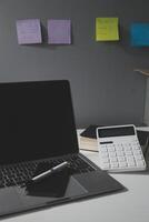 Flat lay, top view office table desk. Workspace with calculator,pen,laptop on white background.Copy Space for text,Empty Blank to word.Business Finance,Education Technology.Work from home. photo
