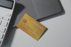 Calculator on a dark background, plastic cards and banknotes photo