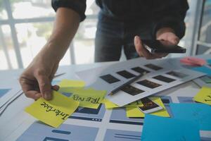ux Graphic designer creative sketch planning application process development prototype wireframe for web mobile phone . User experience concept. photo