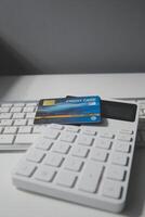 Calculator on a dark background, plastic cards and banknotes photo