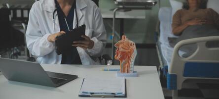 Female doctor explaining to patient results of model the process of patients. Diagnosis of diseases for Model Internal organ. photo