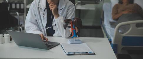 Female doctor explaining to patient results of model the process of patients. Diagnosis of diseases for Model Internal organ. photo