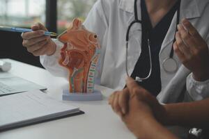 Female doctor explaining to patient results of model the process of patients. Diagnosis of diseases for Model Internal organ. photo