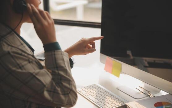 Call center, computer and business with woman in office for customer service, technical support and advice. Technology, contact us and communication with employee operator in help desk agency photo