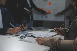 Business team collaboration discussing working analyzing with financial data and marketing growth report graph in team, presentation and brainstorming to strategy planning making profit of company. photo
