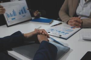 Business team collaboration discussing working analyzing with financial data and marketing growth report graph in team, presentation and brainstorming to strategy planning making profit of company. photo