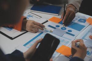 Business team collaboration discussing working analyzing with financial data and marketing growth report graph in team, presentation and brainstorming to strategy planning making profit of company. photo