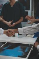 Doctor handshake and partnership in healthcare, medicine or trust for collaboration, unity or support.Team of medical experts shaking hands in teamwork for or success in hospital photo