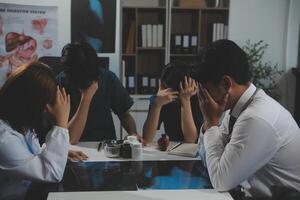 Manager Man Checking Pie Chart Data of Monthly Audit Report and Give a Negative News to his Medical Team in Hospital Boardroom Office or Healthcare Centre Meeting Room photo