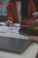 Business team collaboration discussing working analyzing with financial data and marketing growth report graph in team, presentation and brainstorming to strategy planning making profit of company. photo