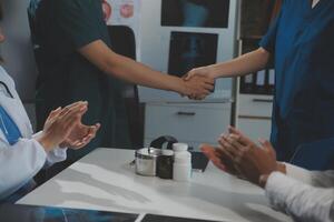 Doctor handshake and partnership in healthcare, medicine or trust for collaboration, unity or support.Team of medical experts shaking hands in teamwork for or success in hospital photo