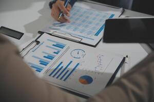 Business team collaboration discussing working analyzing with financial data and marketing growth report graph in team, presentation and brainstorming to strategy planning making profit of company. photo