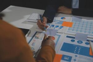 Business team collaboration discussing working analyzing with financial data and marketing growth report graph in team, presentation and brainstorming to strategy planning making profit of company. photo