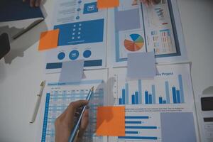 Business team collaboration discussing working analyzing with financial data and marketing growth report graph in team, presentation and brainstorming to strategy planning making profit of company. photo