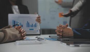 Business team collaboration discussing working analyzing with financial data and marketing growth report graph in team, presentation and brainstorming to strategy planning making profit of company. photo