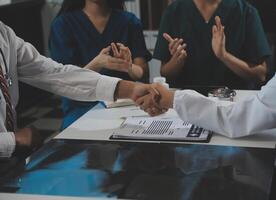 Doctor handshake and partnership in healthcare, medicine or trust for collaboration, unity or support.Team of medical experts shaking hands in teamwork for or success in hospital photo