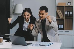 Two happy friendly diverse professionals, teacher and student giving high five standing in office celebrating success, good cooperation result, partnership teamwork and team motivation in office work. photo