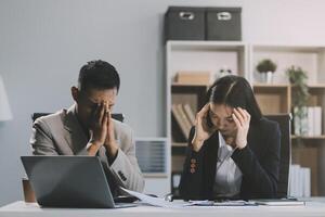 Manager is hard talking with employee in an office. Businessmen arguing at workplace, disagreeing over document, partners having conflict while negotiating, business deal failure photo