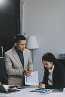 Manager is hard talking with employee in an office. Businessmen arguing at workplace, disagreeing over document, partners having conflict while negotiating, business deal failure photo