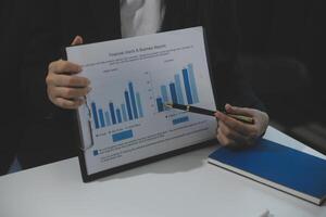 Business team collaboration discussing working analyzing with financial data and marketing growth report graph in team, presentation and brainstorming to strategy planning making profit of company. photo