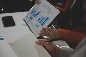 Business team collaboration discussing working analyzing with financial data and marketing growth report graph in team, presentation and brainstorming to strategy planning making profit of company. photo