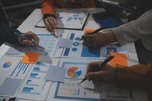 Business team collaboration discussing working analyzing with financial data and marketing growth report graph in team, presentation and brainstorming to strategy planning making profit of company. photo