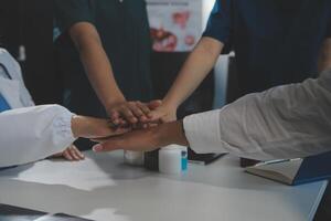 Doctor handshake and partnership in healthcare, medicine or trust for collaboration, unity or support.Team of medical experts shaking hands in teamwork for or success in hospital photo
