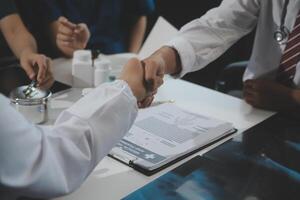 Doctor handshake and partnership in healthcare, medicine or trust for collaboration, unity or support.Team of medical experts shaking hands in teamwork for or success in hospital photo