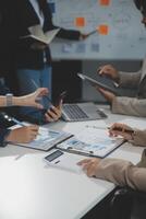 Business team collaboration discussing working analyzing with financial data and marketing growth report graph in team, presentation and brainstorming to strategy planning making profit of company. photo
