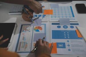 Business team collaboration discussing working analyzing with financial data and marketing growth report graph in team, presentation and brainstorming to strategy planning making profit of company. photo