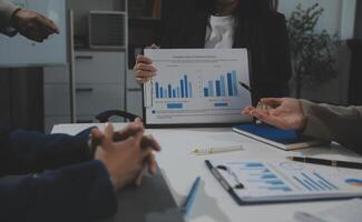 Business team collaboration discussing working analyzing with financial data and marketing growth report graph in team, presentation and brainstorming to strategy planning making profit of company. photo