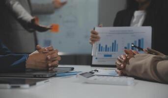 Business team collaboration discussing working analyzing with financial data and marketing growth report graph in team, presentation and brainstorming to strategy planning making profit of company. photo