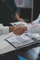 Doctor handshake and partnership in healthcare, medicine or trust for collaboration, unity or support.Team of medical experts shaking hands in teamwork for or success in hospital photo