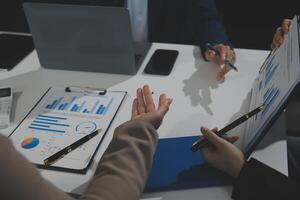 Business team collaboration discussing working analyzing with financial data and marketing growth report graph in team, presentation and brainstorming to strategy planning making profit of company. photo