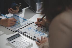 Business team collaboration discussing working analyzing with financial data and marketing growth report graph in team, presentation and brainstorming to strategy planning making profit of company. photo