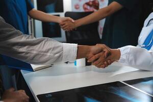 Doctor handshake and partnership in healthcare, medicine or trust for collaboration, unity or support.Team of medical experts shaking hands in teamwork for or success in hospital photo