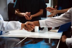 Doctor handshake and partnership in healthcare, medicine or trust for collaboration, unity or support.Team of medical experts shaking hands in teamwork for or success in hospital photo