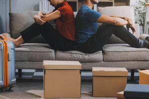 Man and woman sitting on sofa in quarrel, not talking to each other. Concept of relationship problems photo