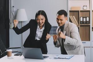 Two happy friendly diverse professionals, teacher and student giving high five standing in office celebrating success, good cooperation result, partnership teamwork and team motivation in office work. photo