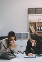 Manager is hard talking with employee in an office. Businessmen arguing at workplace, disagreeing over document, partners having conflict while negotiating, business deal failure photo