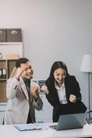 Two happy friendly diverse professionals, teacher and student giving high five standing in office celebrating success, good cooperation result, partnership teamwork and team motivation in office work. photo