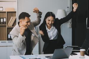 Two happy friendly diverse professionals, teacher and student giving high five standing in office celebrating success, good cooperation result, partnership teamwork and team motivation in office work. photo