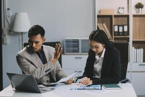 Manager is hard talking with employee in an office. Businessmen arguing at workplace, disagreeing over document, partners having conflict while negotiating, business deal failure photo