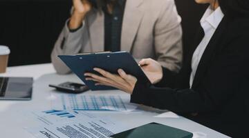 Business team present. Business man hands hold documents with financial statistic stock photo, discussion, and analysis report data the charts and graphs. Finance concept photo
